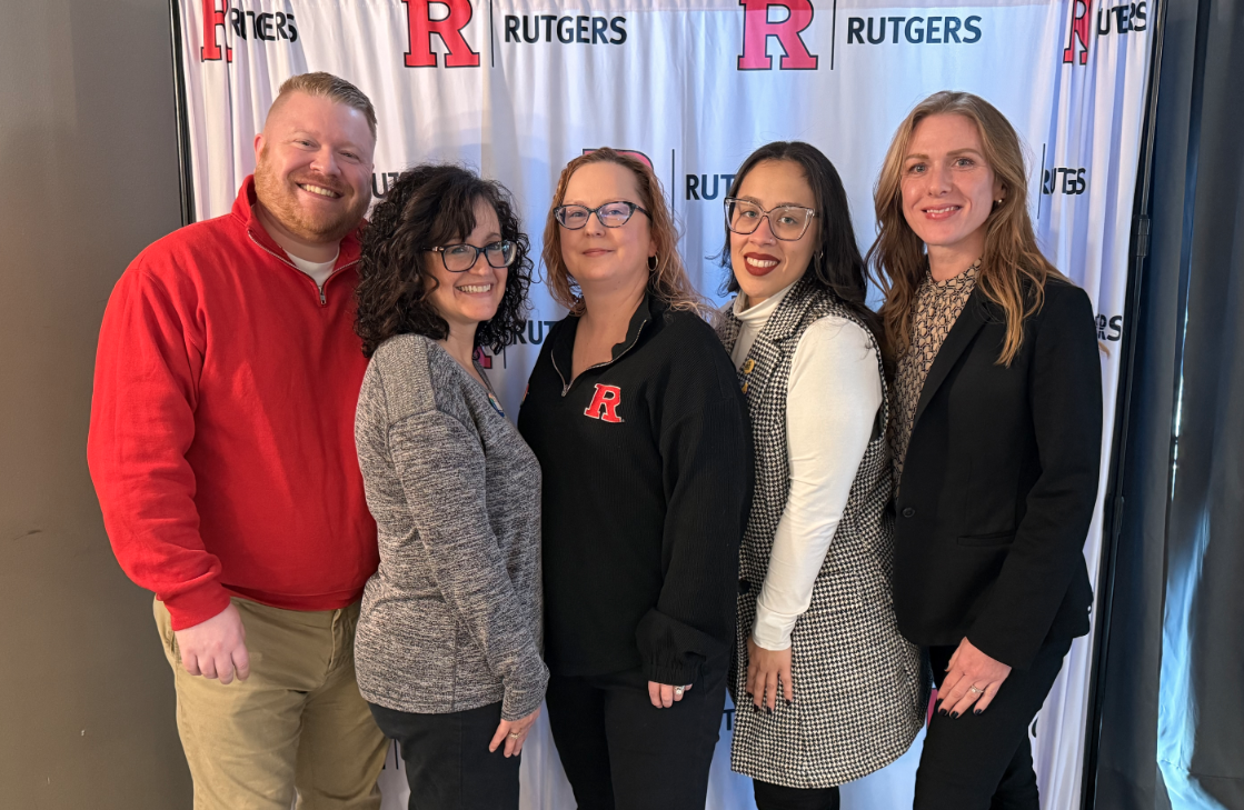 image of the Center for Continuing Education team in front of a Rutgers banner