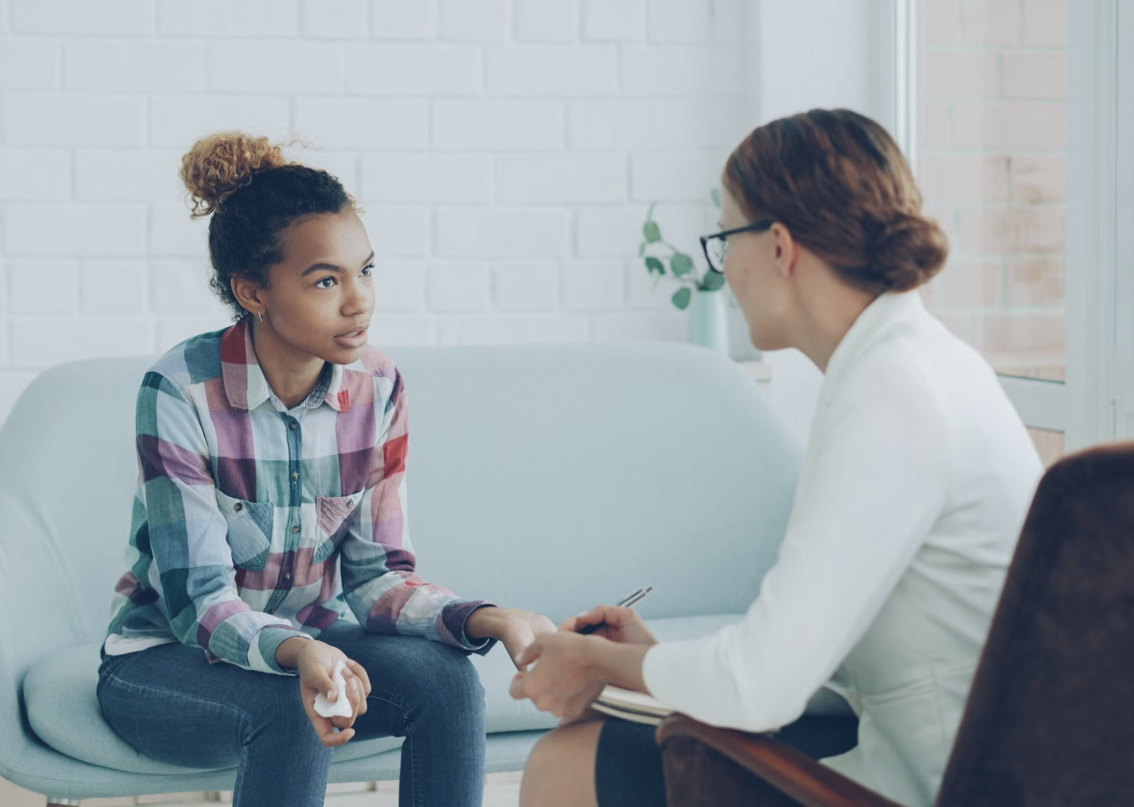 Young person speaks with a behavioral health professional during an individual counseling session.