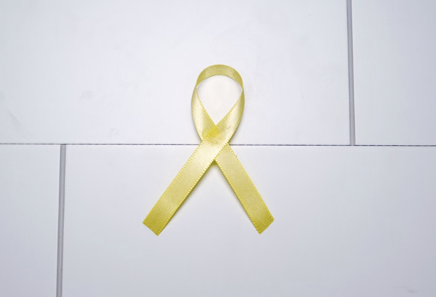 Yellow awareness ribbon displayed against a white background.