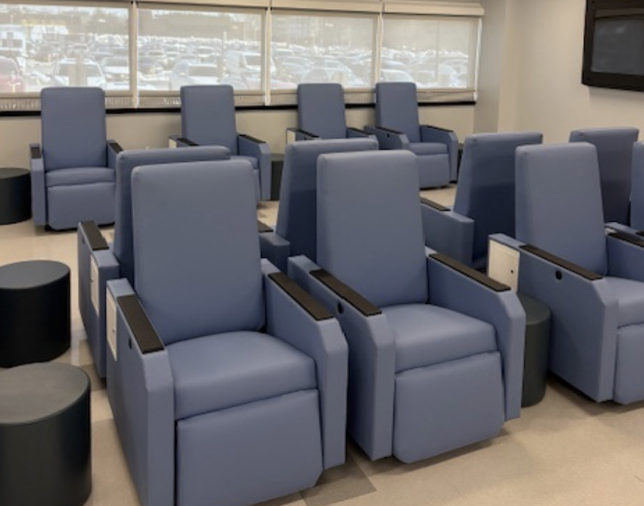 image of holding chairs from program in rows in room with windows.