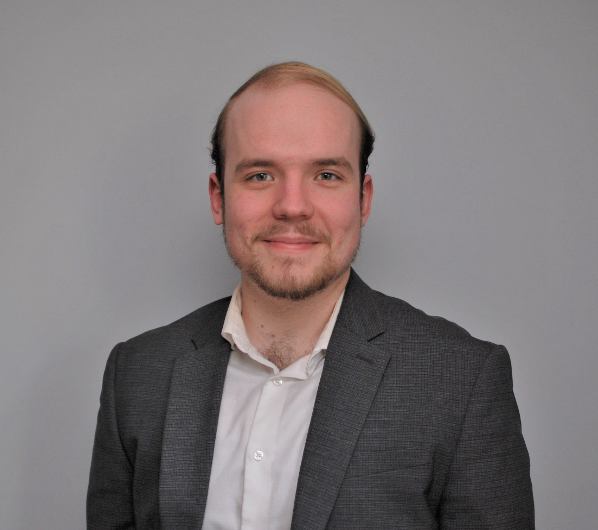 Professional photo with grey background of Tom O'Kane, PhD